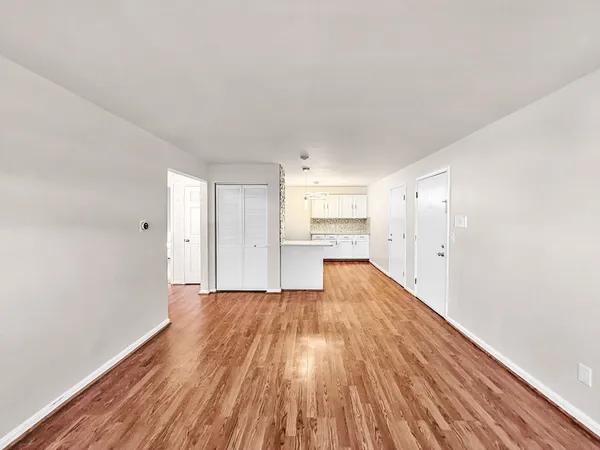 a view of a kitchen with wooden floor