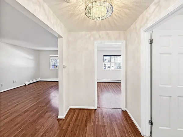 a view of empty room with wooden floor