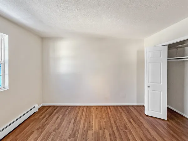 a view of an empty room and wooden floor