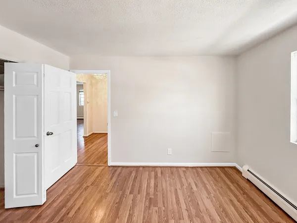 a view of a room with wooden floor and closet