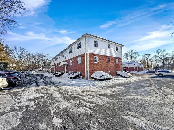 a view of a house with a yard covered in snow