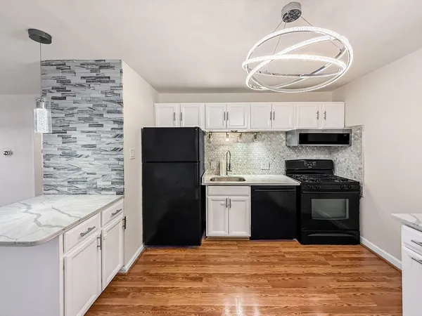 a kitchen with a stove a sink and a refrigerator