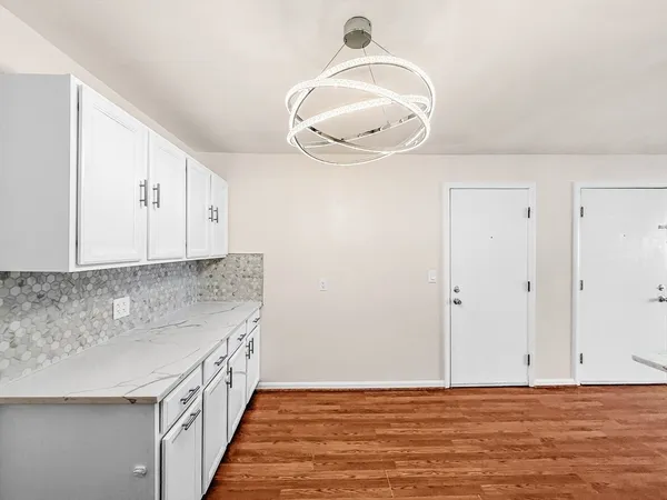 a view of a kitchen with wooden floor