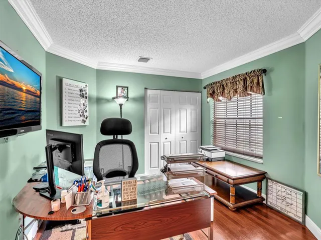 a living room with furniture a flat screen tv and a window