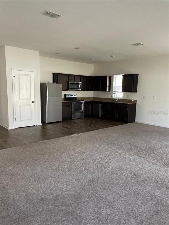 4824 Osprey Way Winter Haven, FL 33881 - Photo 2 of 5 a living room with furniture and a kitchen