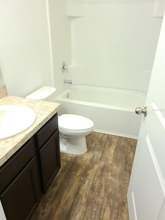 4824 Osprey Way Winter Haven, FL 33881 - Photo 5 of 5 a bathroom with a granite countertop sink a toilet and bathtub