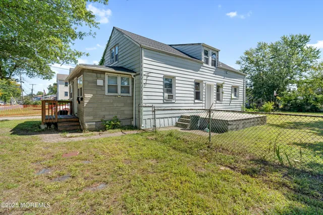 a backyard of a house with table and chairs