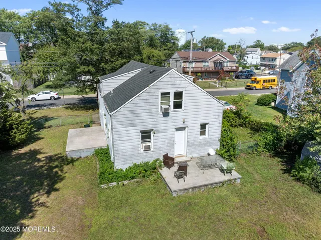 a aerial view of a house with a yard table and chairs