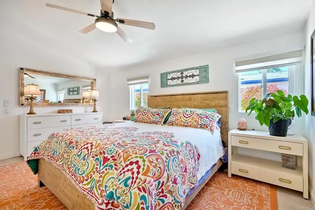 a bedroom with bed and wooden floor