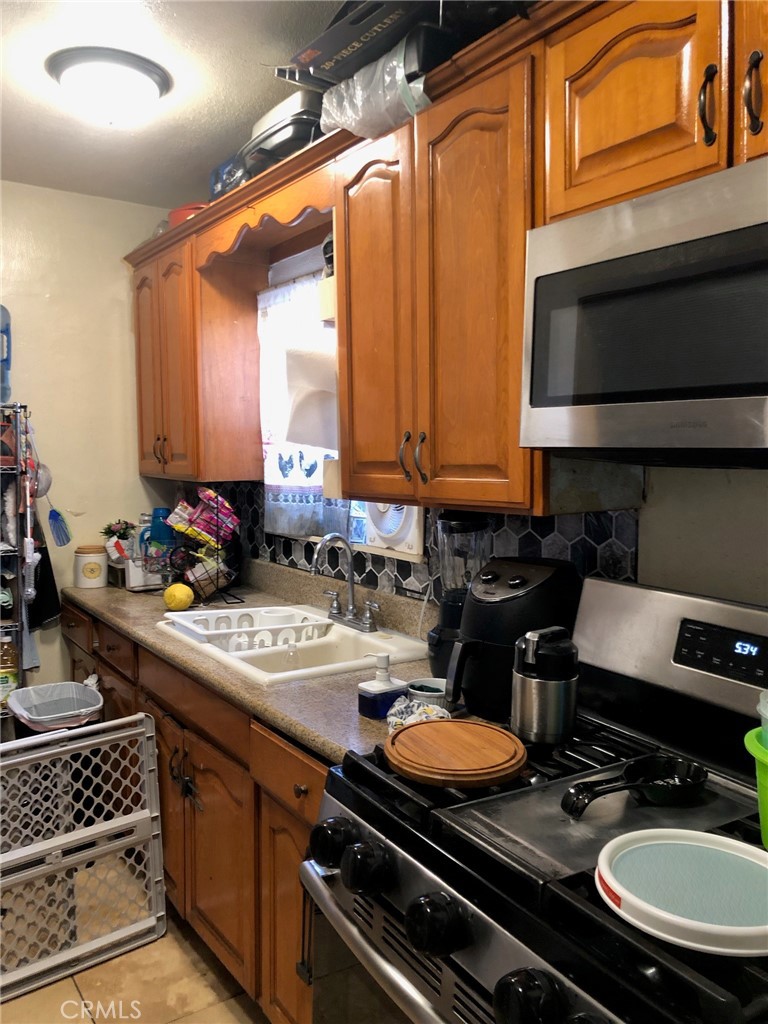 1512 West 152nd Street Compton, CA 90220 - Photo 8 of 14 a kitchen with a stove and a sink