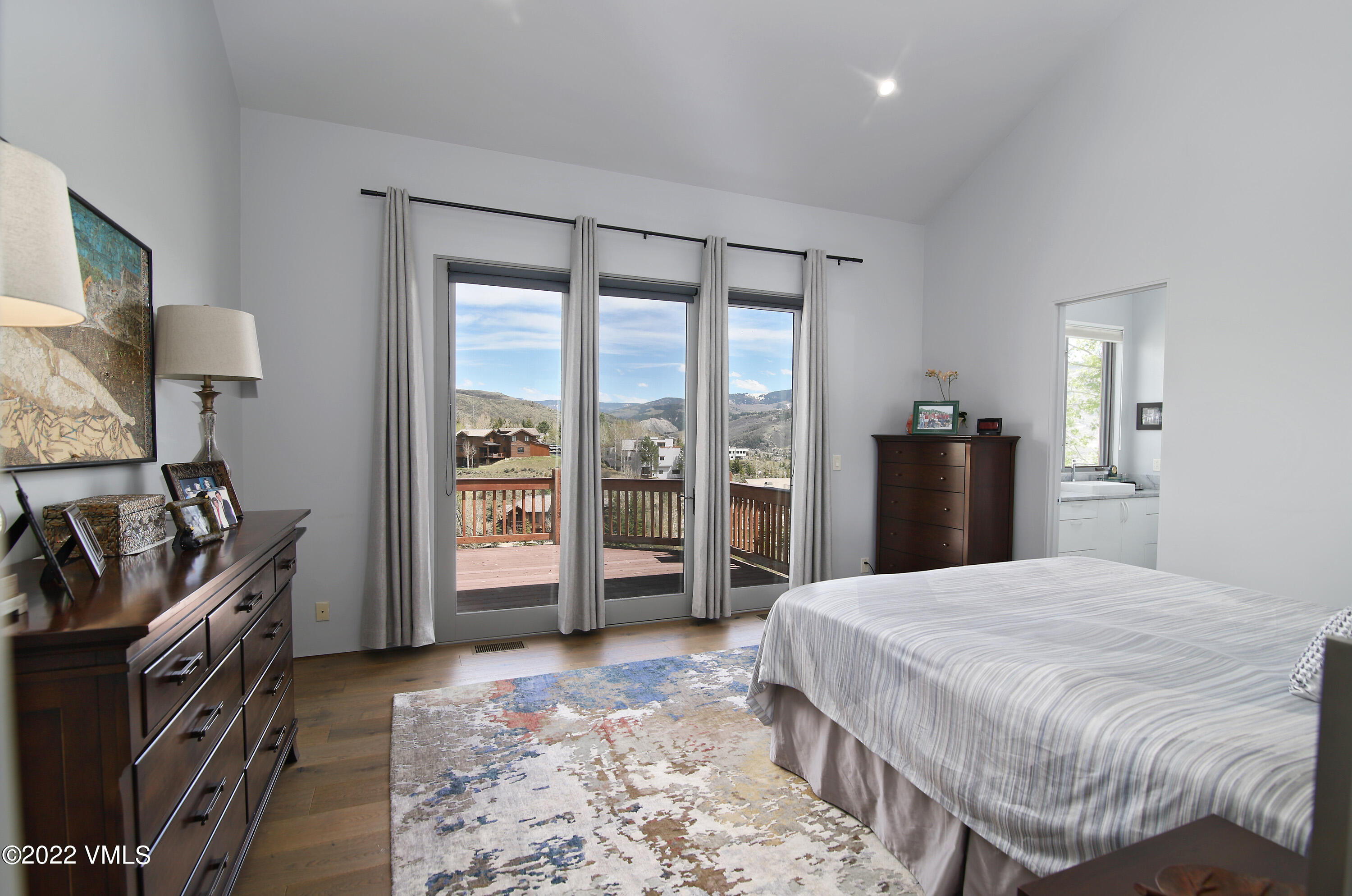 11 Chute Circle Edwards, CO 81632 - Photo 11 of 18 a spacious bedroom with a bed and a dresser in it