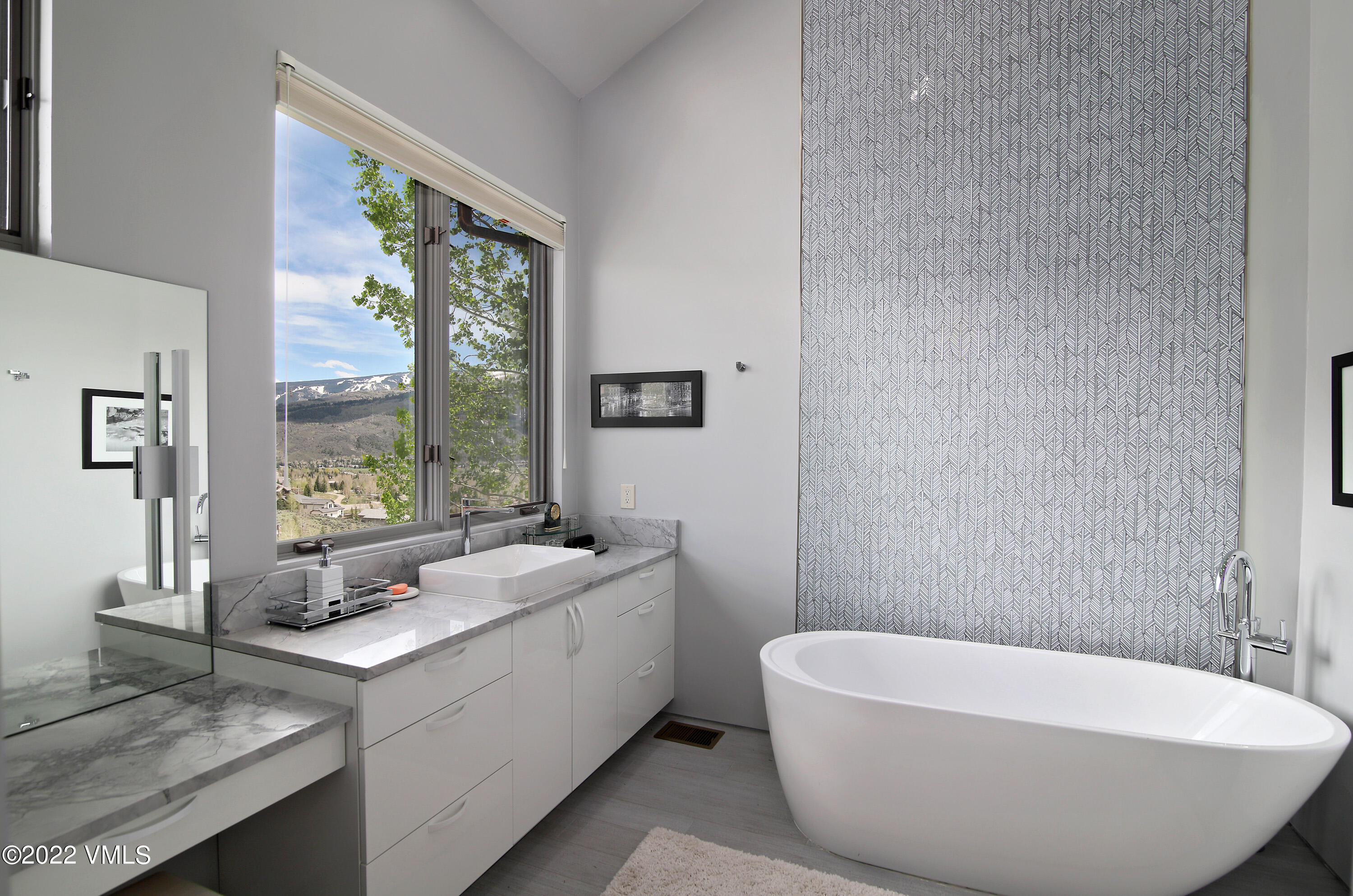 11 Chute Circle Edwards, CO 81632 - Photo 12 of 18 a bathroom with a white tub a sink and a large window