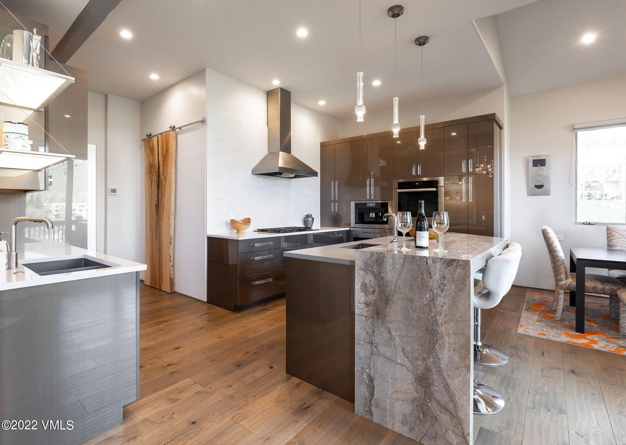 11 Chute Circle Edwards, CO 81632 - Photo 6 of 18 a kitchen with stainless steel appliances granite countertop a refrigerator a stove and a wooden floors