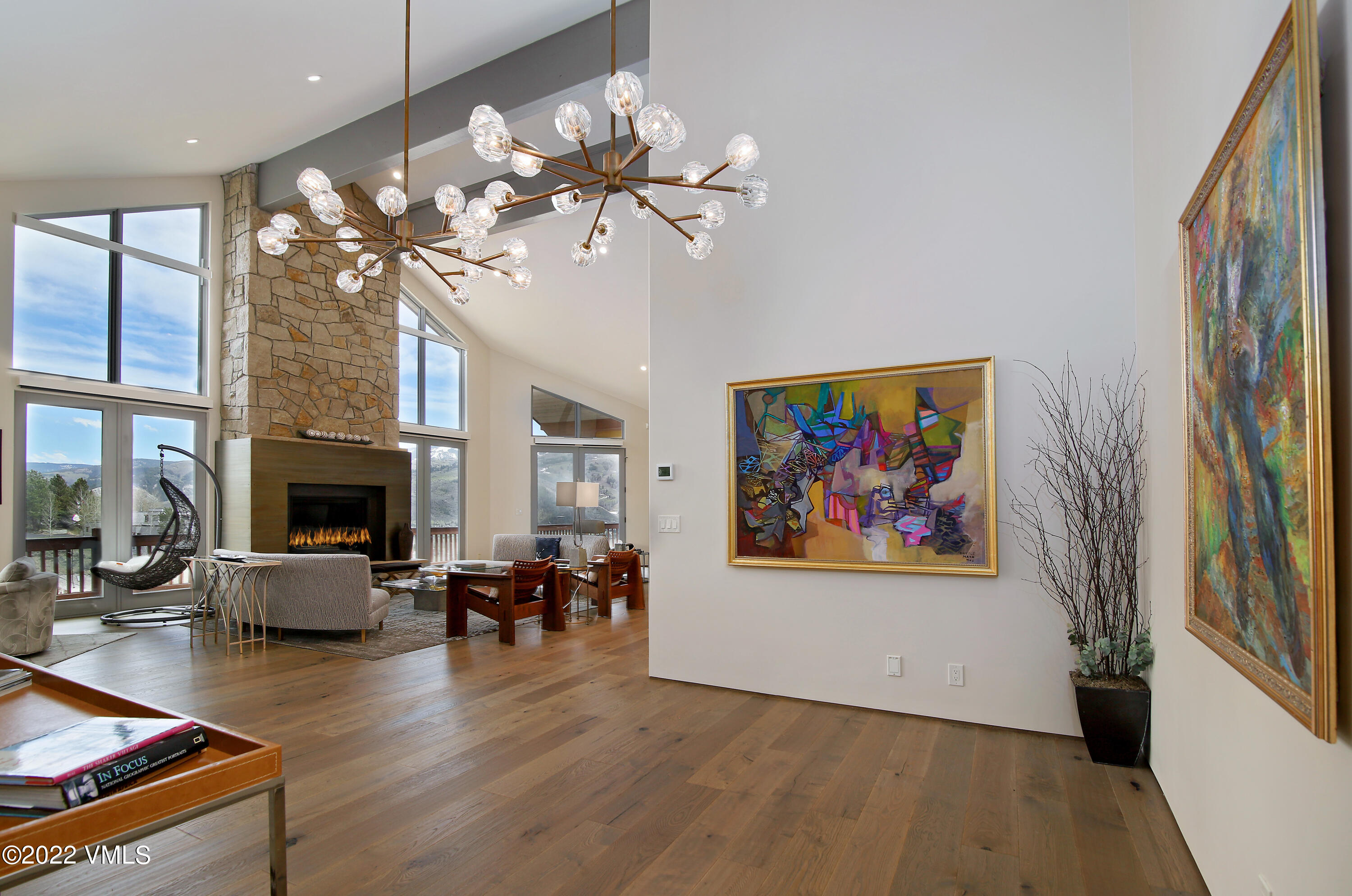 11 Chute Circle Edwards, CO 81632 - Photo 7 of 18 a view of a livingroom with furniture a fireplace wooden floor and chandelier