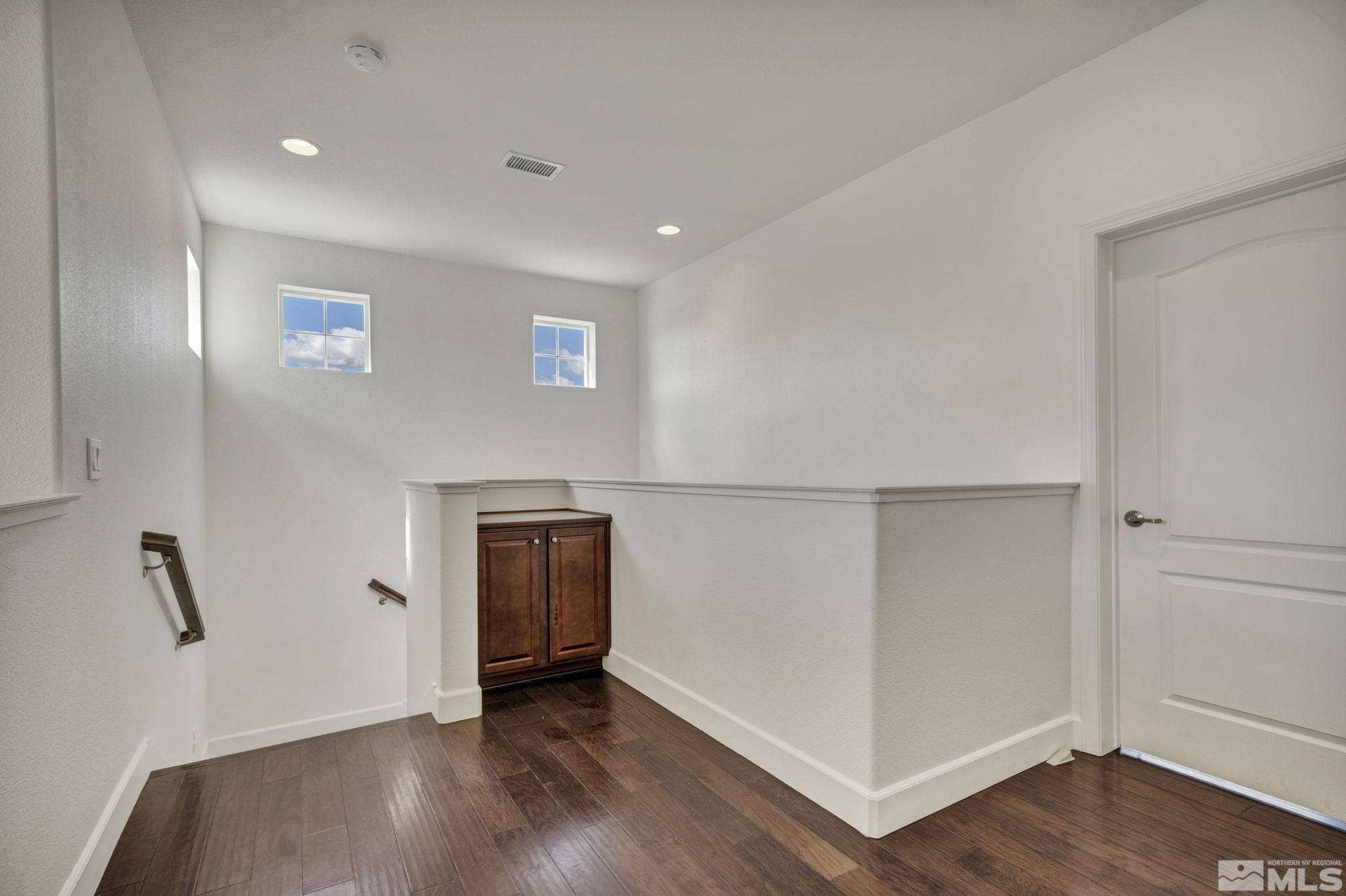 10345 Rollins Drive Reno, NV 89521 - Photo 15 of 39 an empty room with wooden floor and natural light