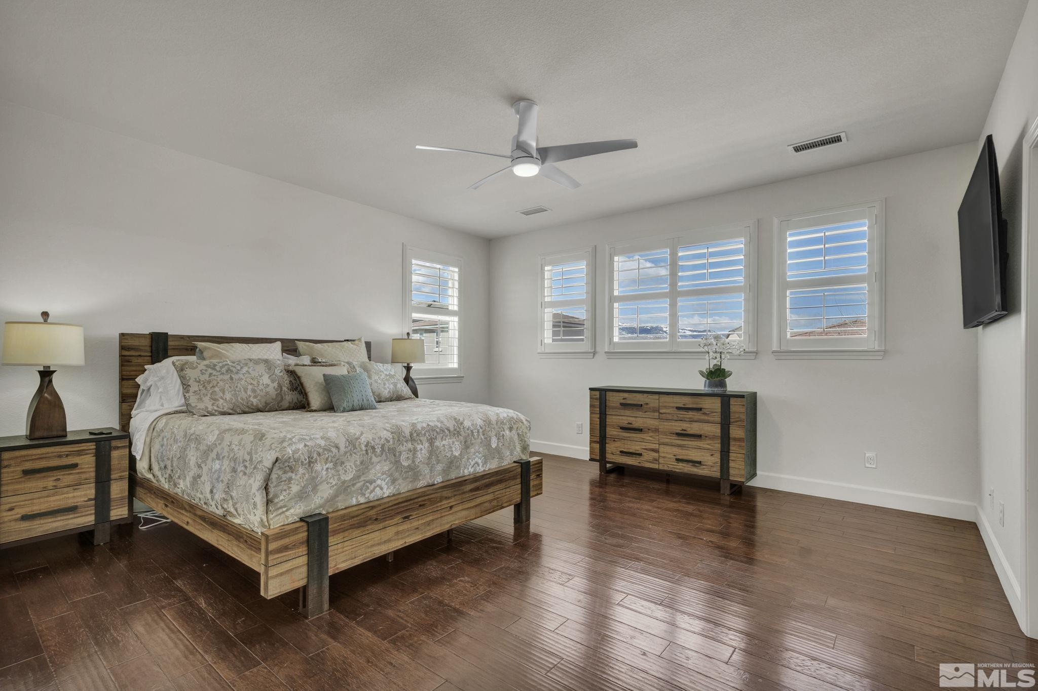 10345 Rollins Drive Reno, NV 89521 - Photo 16 of 39 a spacious bedroom with a bed and a flat screen tv