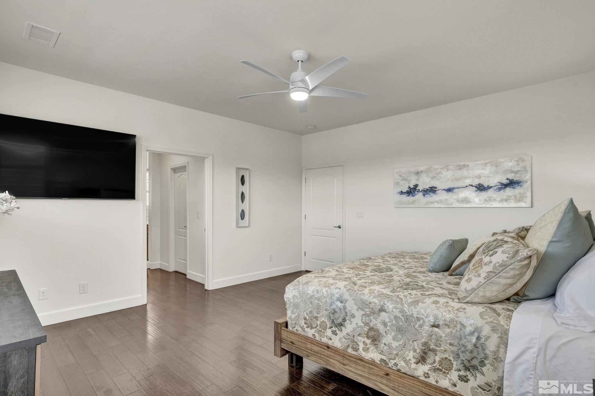 10345 Rollins Drive Reno, NV 89521 - Photo 18 of 39 a bedroom with a bed and a flat screen tv