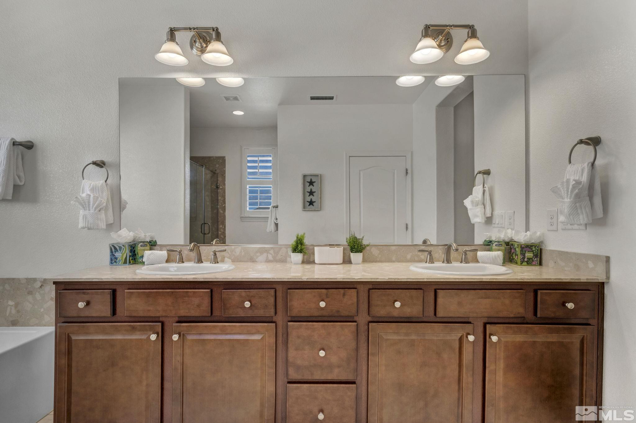 10345 Rollins Drive Reno, NV 89521 - Photo 20 of 39 a bathroom with a double vanity sink and a mirror