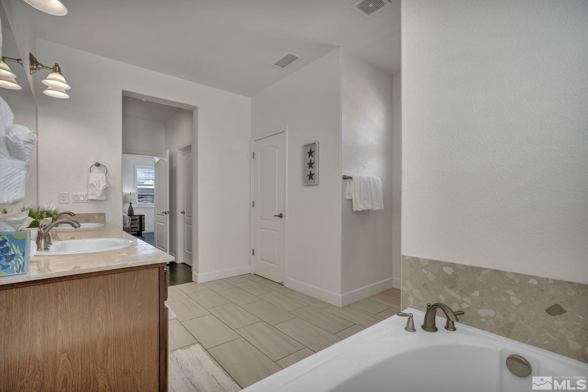 10345 Rollins Drive Reno, NV 89521 - Photo 21 of 39 a bathroom with a sink and a mirror