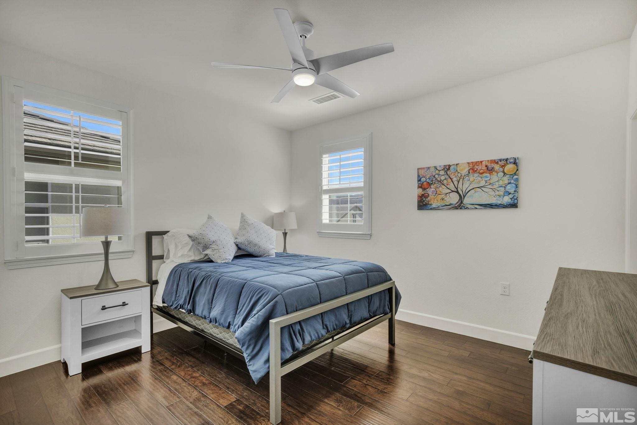 10345 Rollins Drive Reno, NV 89521 - Photo 22 of 39 a bedroom with a bed wooden floor and window