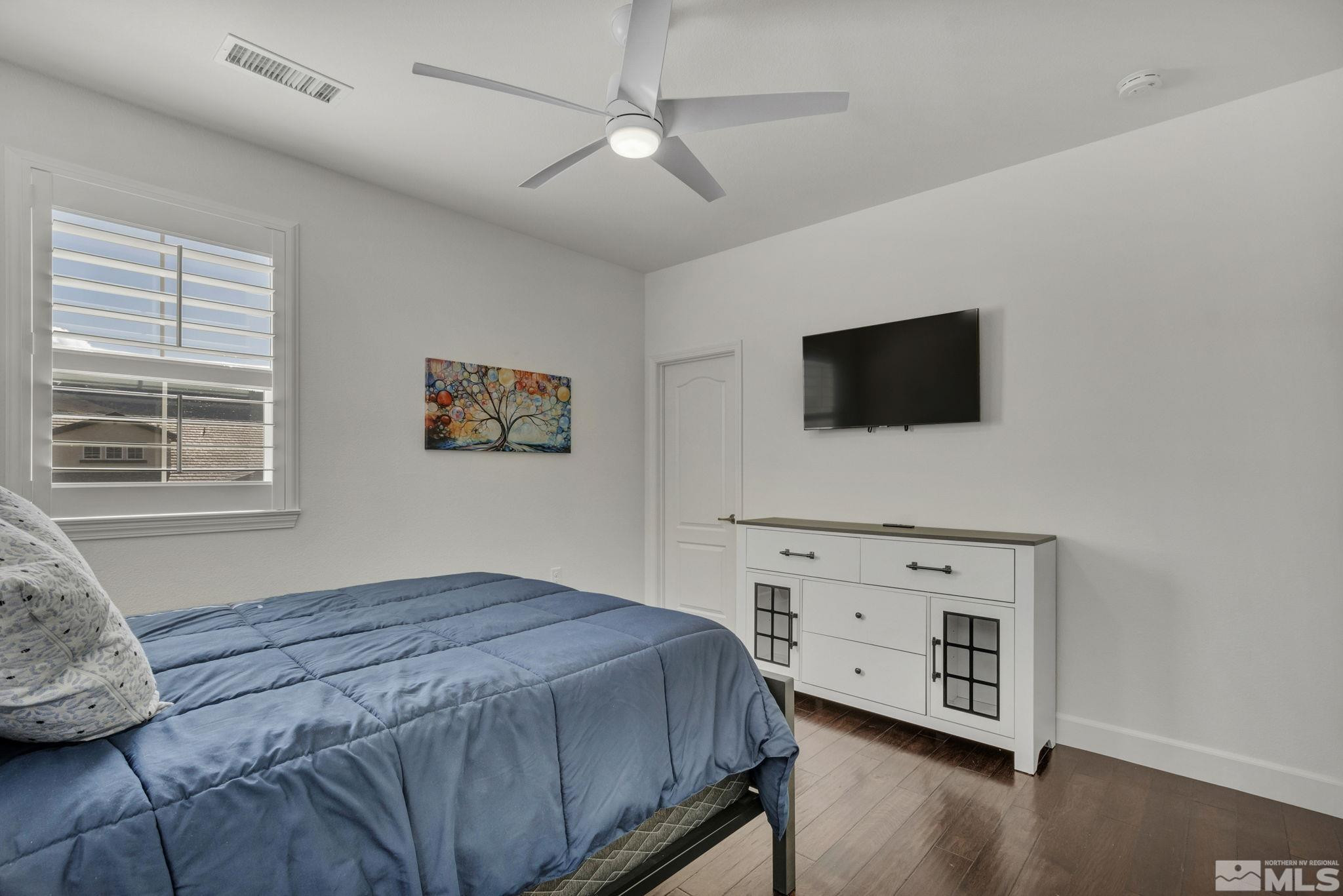 10345 Rollins Drive Reno, NV 89521 - Photo 23 of 39 a bedroom with a bed and a flat screen tv