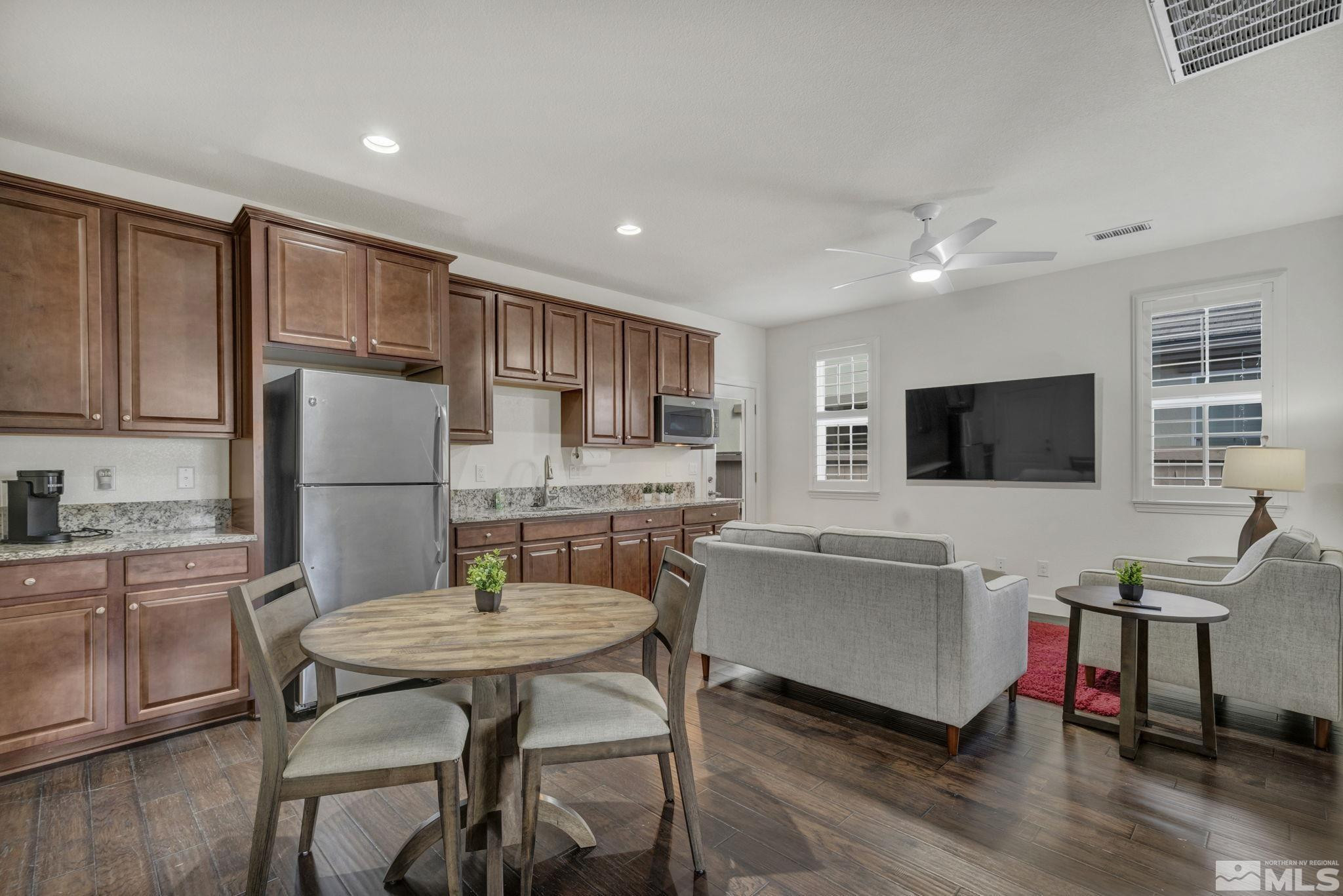 10345 Rollins Drive Reno, NV 89521 - Photo 27 of 39 a living room with stainless steel appliances furniture a flat screen tv and kitchen view