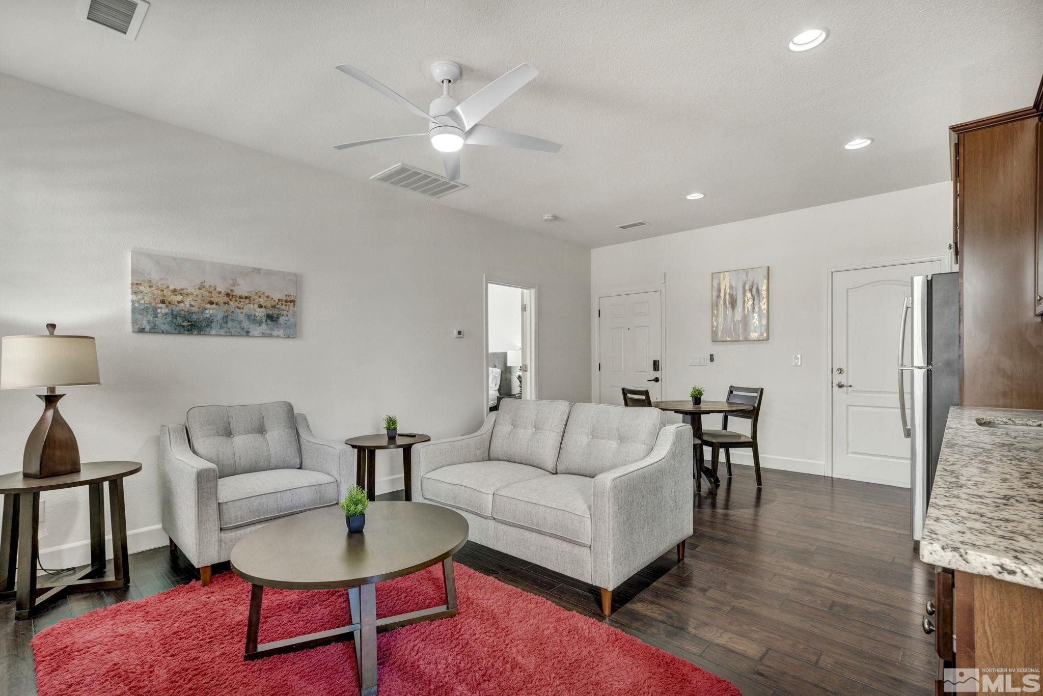 10345 Rollins Drive Reno, NV 89521 - Photo 28 of 39 a living room with furniture and a dining table with wooden floor