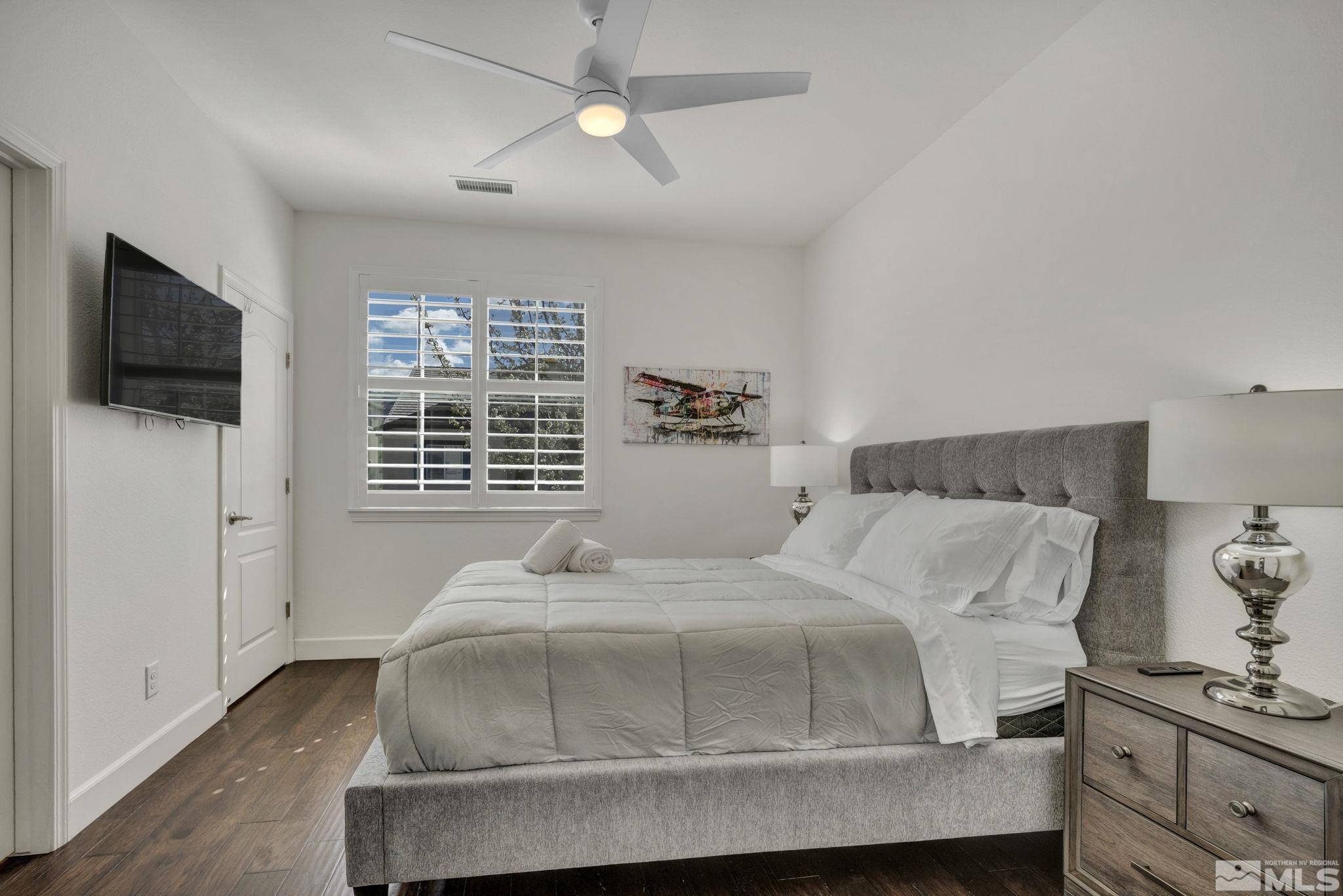 10345 Rollins Drive Reno, NV 89521 - Photo 29 of 39 a bedroom with a bed and a flat screen tv