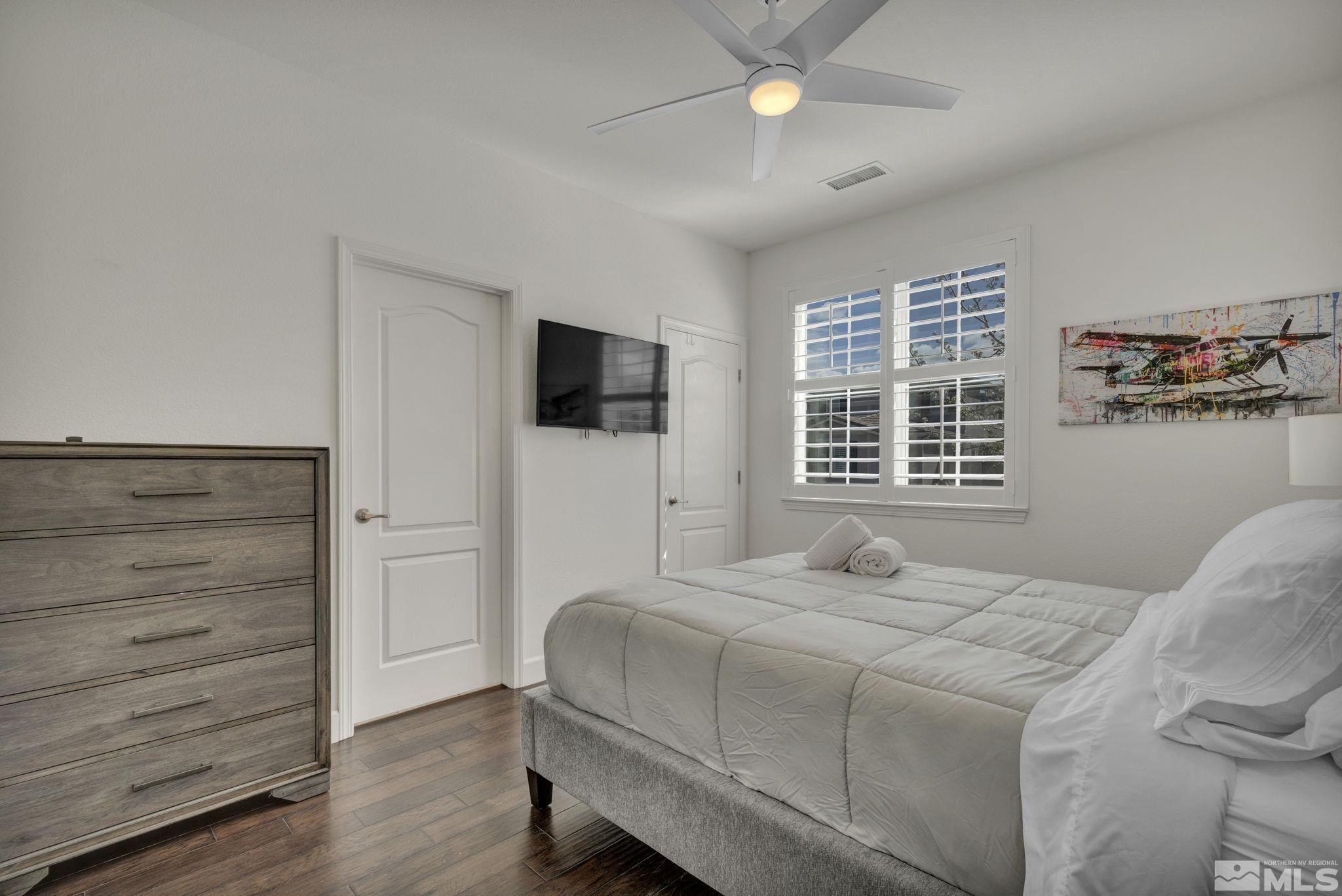 10345 Rollins Drive Reno, NV 89521 - Photo 30 of 39 a bedroom with a bed and a flat tv screen