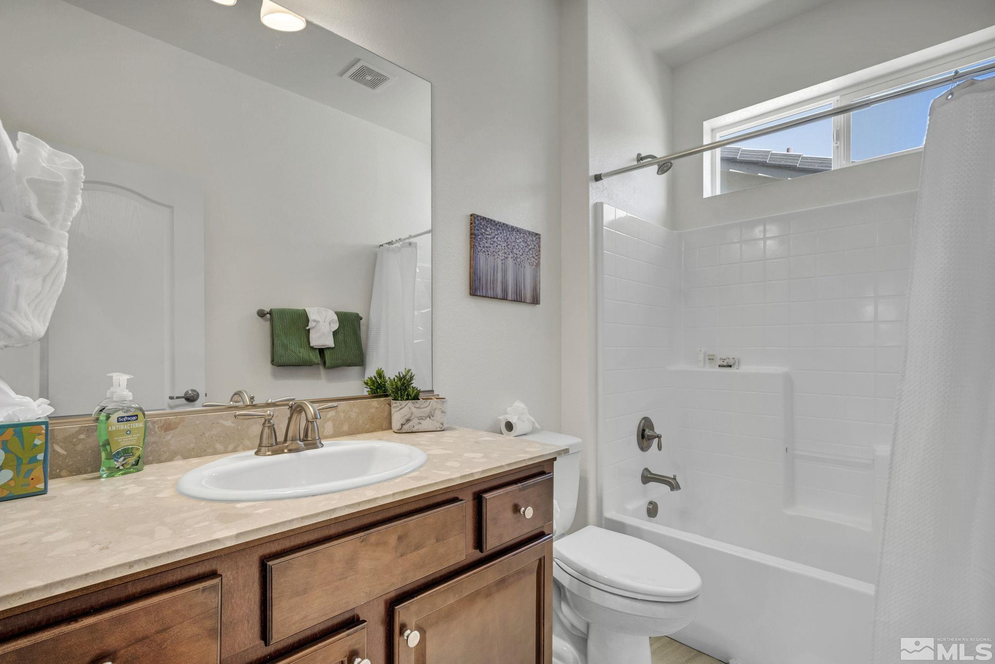 10345 Rollins Drive Reno, NV 89521 - Photo 31 of 39 a bathroom with a granite countertop sink toilet and shower