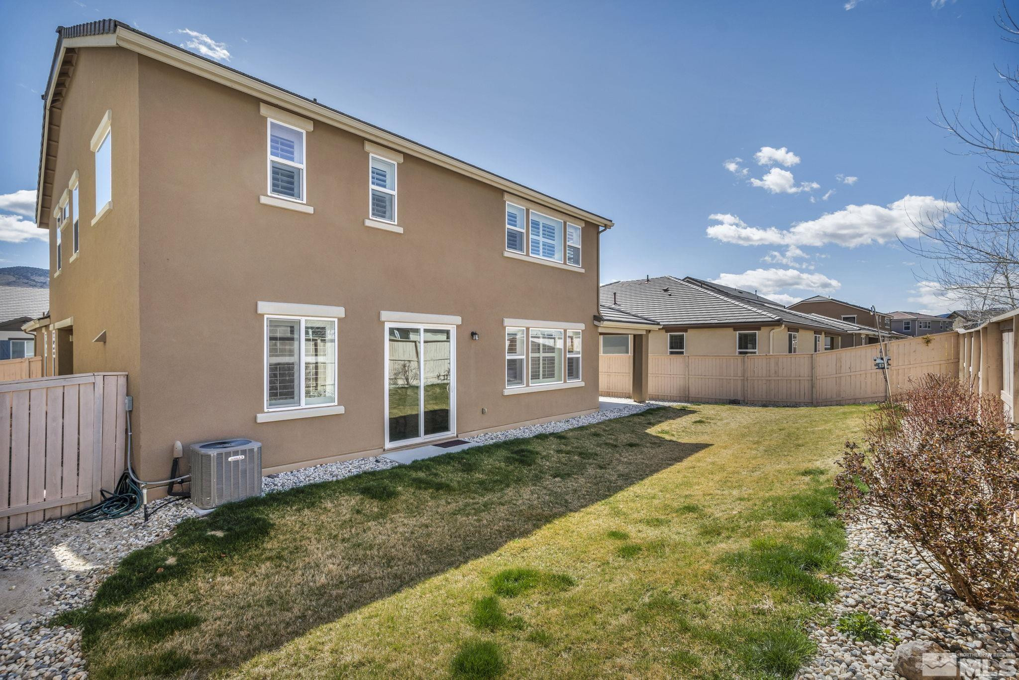 10345 Rollins Drive Reno, NV 89521 - Photo 35 of 39 a front view of a house with a yard and garage