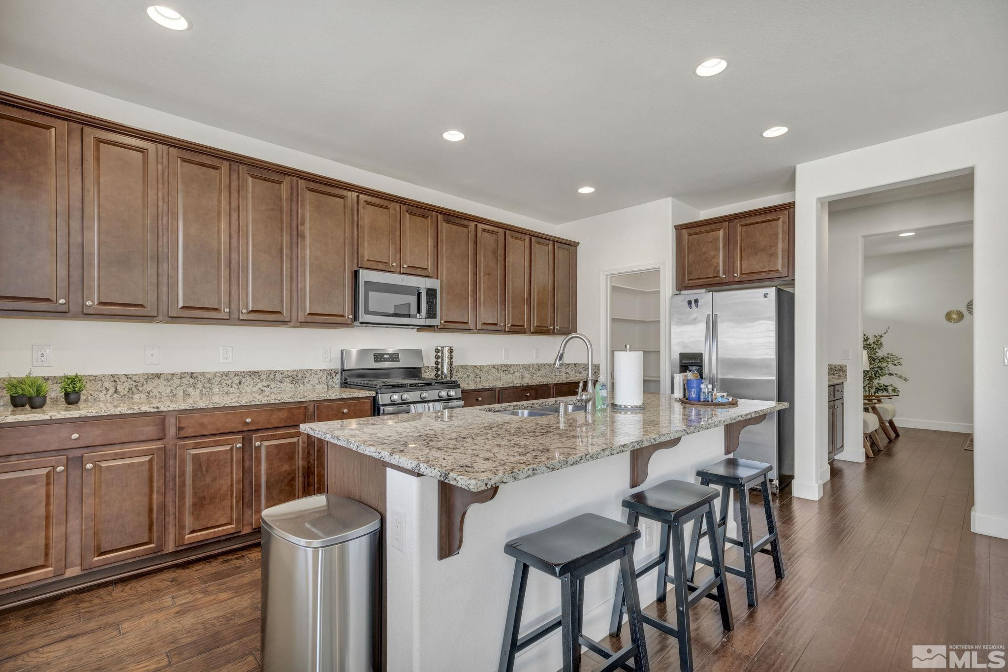 10345 Rollins Drive Reno, NV 89521 - Photo 4 of 39 a kitchen with sink cabinets and wooden floor