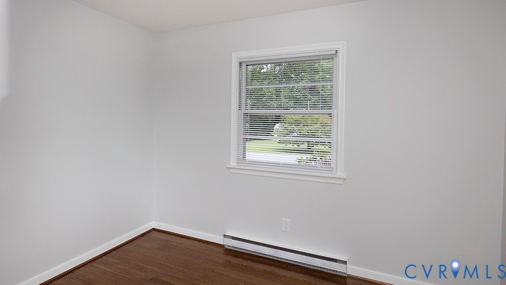 7397 Ewell Road Mechanicsville, VA 23111 - Photo 16 of 42 Spare room featuring a baseboard radiator and dark