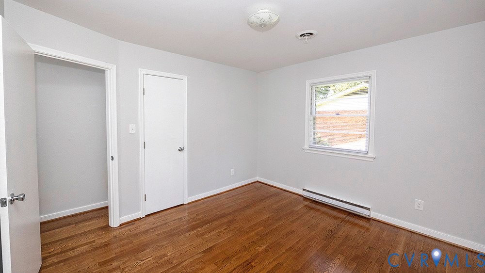 7397 Ewell Road Mechanicsville, VA 23111 - Photo 23 of 42 Unfurnished bedroom featuring dark wood-style floo