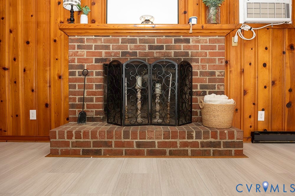 7397 Ewell Road Mechanicsville, VA 23111 - Photo 9 of 42 Detailed view of wooden walls, a brick fireplace,