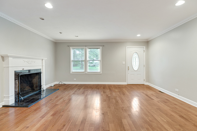 1211 Telegraph Road Lake Forest, IL 60045 - Photo 2 of 21 an empty room with wooden floor fireplace and windows