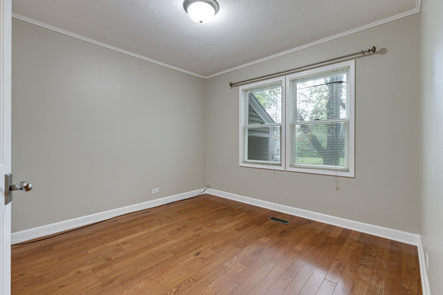1211 Telegraph Road Lake Forest, IL 60045 - Photo 11 of 21 wooden floor in an empty room with a window