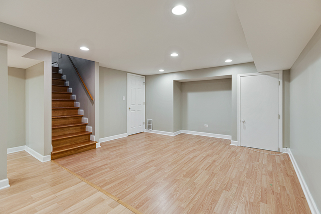 1211 Telegraph Road Lake Forest, IL 60045 - Photo 12 of 21 a view of an empty room with wooden floor and stairs