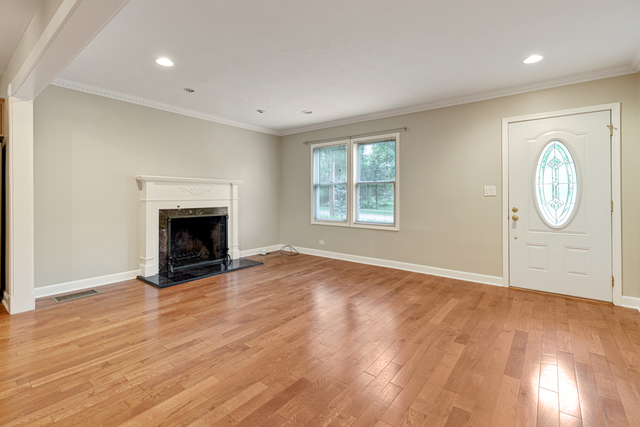 1211 Telegraph Road Lake Forest, IL 60045 - Photo 4 of 21 an empty room with wooden floor a fireplace and window