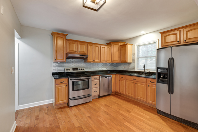 1211 Telegraph Road Lake Forest, IL 60045 - Photo 5 of 21 a kitchen with sink a refrigerator and wooden floor