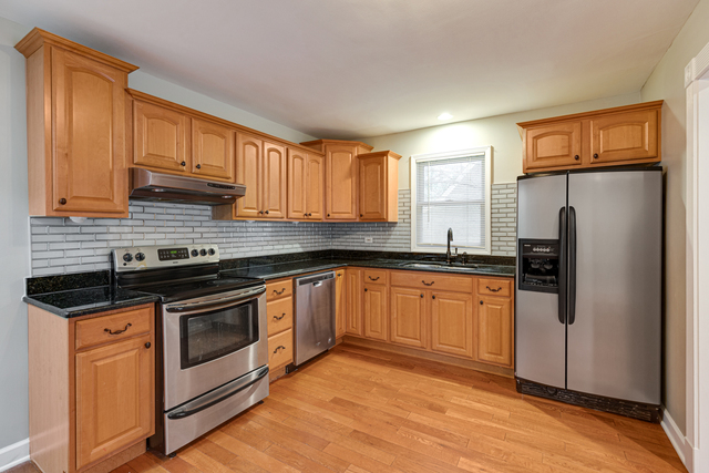 1211 Telegraph Road Lake Forest, IL 60045 - Photo 6 of 21 a kitchen with granite countertop a refrigerator stove and sink