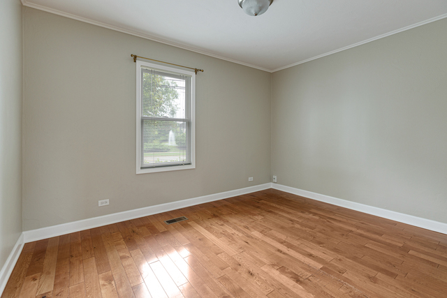 1211 Telegraph Road Lake Forest, IL 60045 - Photo 9 of 21 a view of an empty room with wooden floor and a window