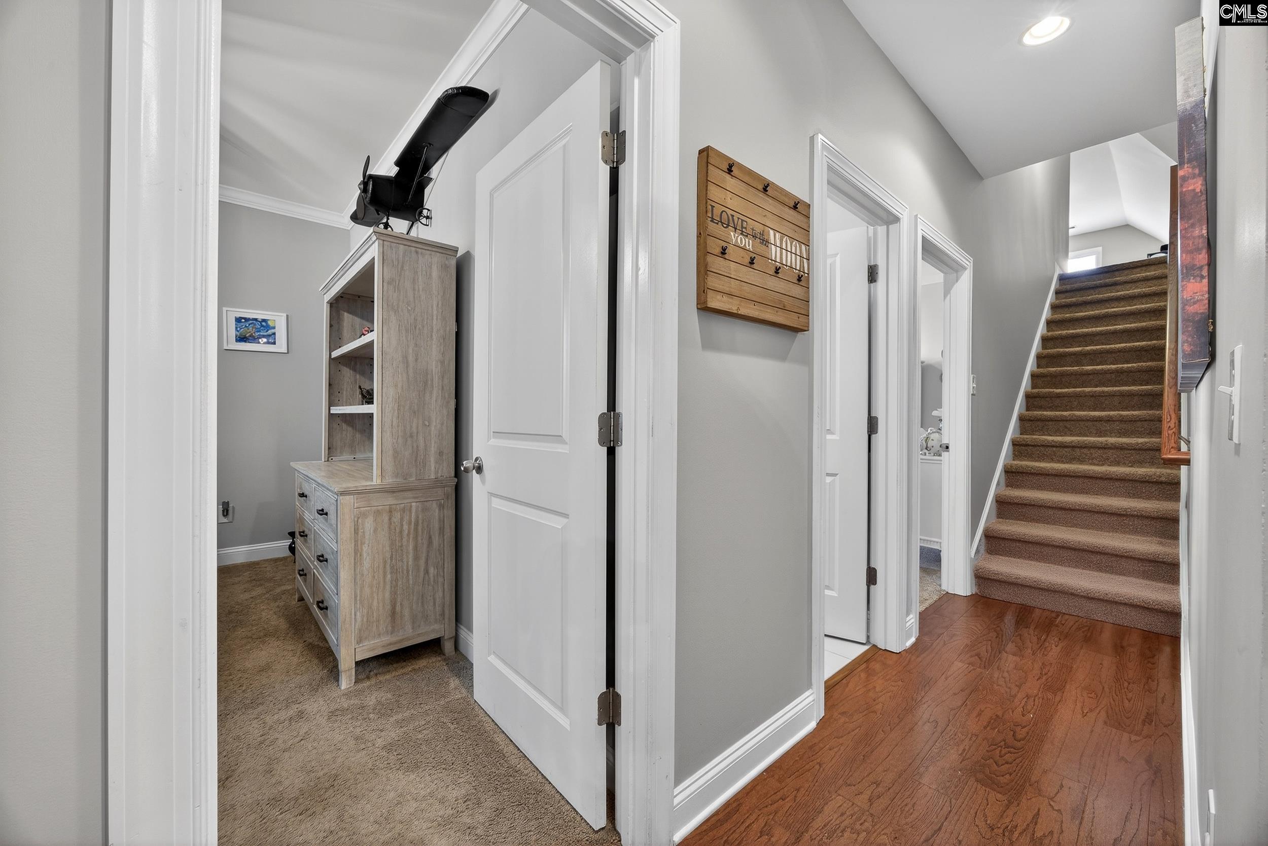 116 Renard Way Gilbert, SC 29054 - Photo 42 of 74 a view of hallway with stairs and wooden floor