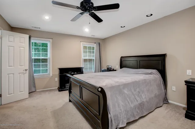 a bedroom with a large bed and a chandelier