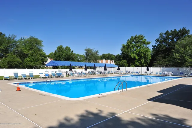 a view of a swimming pool with outdoor seating