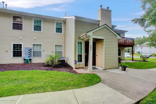 a front view of a house with a garden and plants