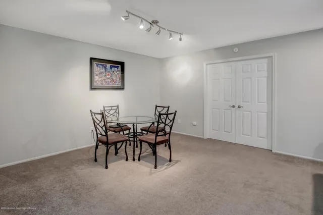 a view of a room that has a table and chairs in it