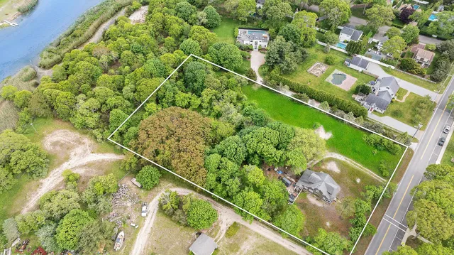 an aerial view of a residential houses with outdoor space and street view
