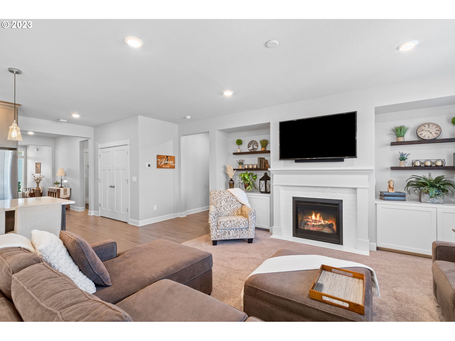 4805 South 17th Way Ridgefield, WA 98642 - Photo 12 of 33 a living room with furniture a fireplace and a flat screen tv