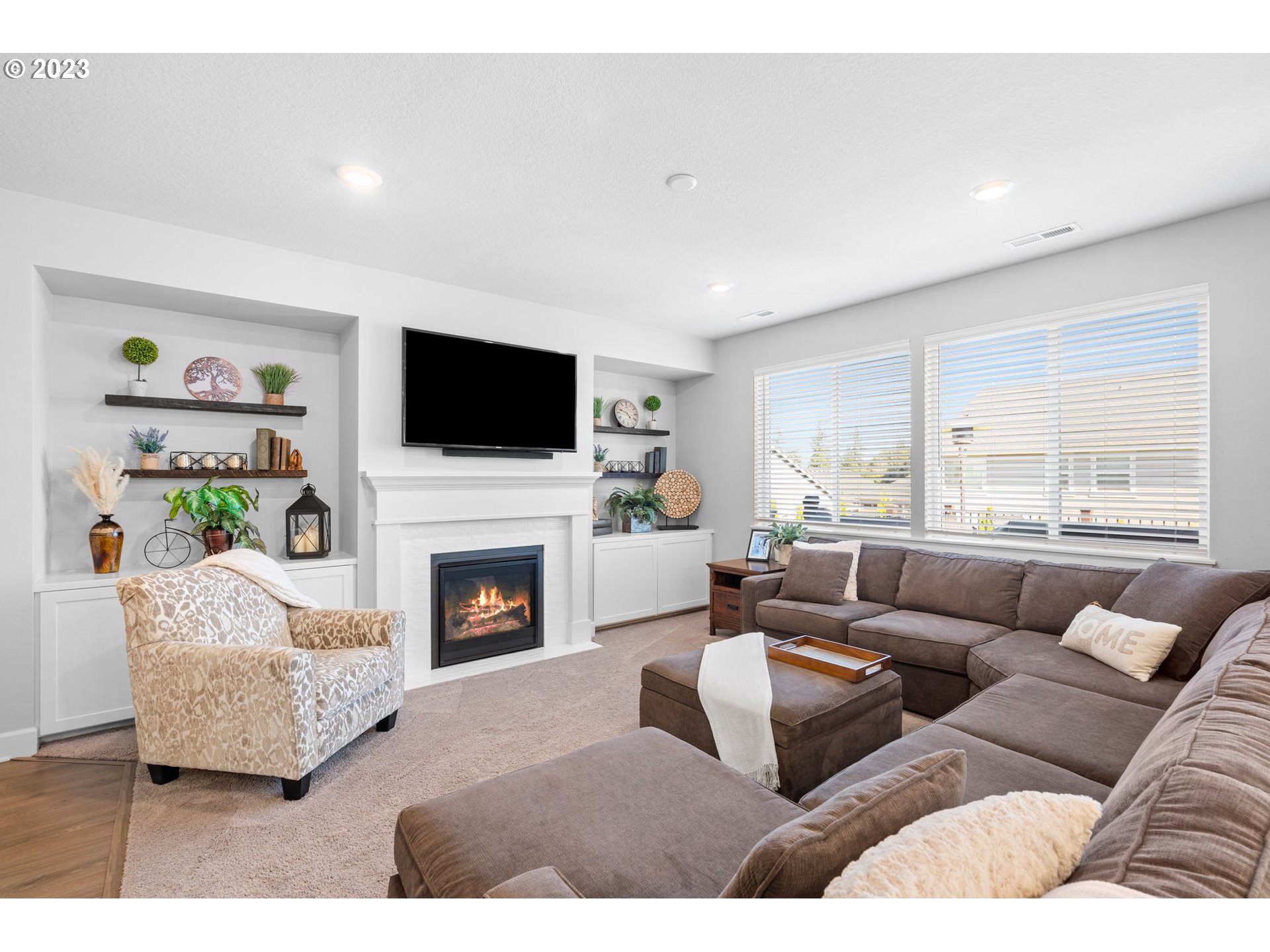 4805 South 17th Way Ridgefield, WA 98642 - Photo 13 of 33 a living room with furniture a fireplace and a flat screen tv